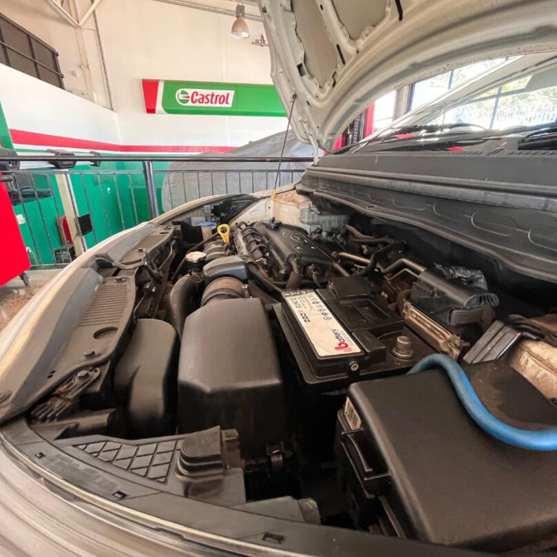 Car service for a car at Castrol Auto Service Northcliff, bonnet is open and the inside with all parts like battery and engine is shown